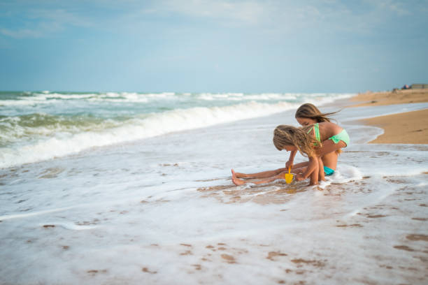 istock Kids play at sea shore 669962482