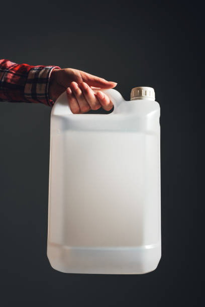 istock White unlabeled plastic 5 liters tank canister in female hand 669977430
