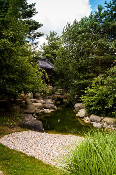 istock Natural small brook in park with chinese house 669978512