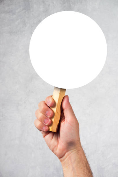 istock Male hand holding blank mock up banner sign as copyspace 669978946