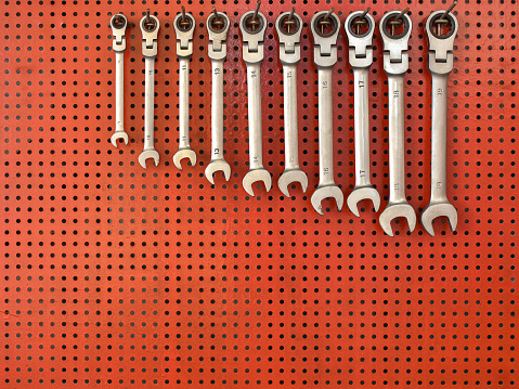 Wrench and screw-nut on set on a wood table background