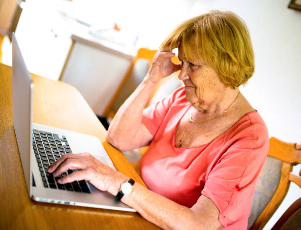istock Mature woman struggling to use internet 669982682