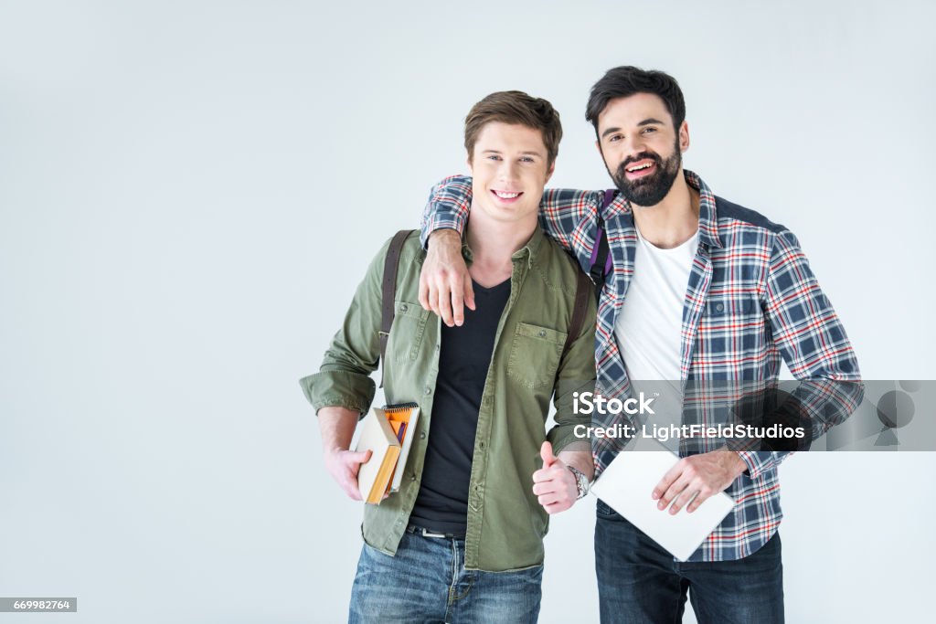 young students holding books on white with copy space Adult Student Stock Photo