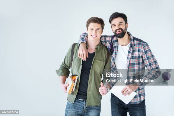 Young Students Holding Books On White With Copy Space Stock Photo - Download Image Now