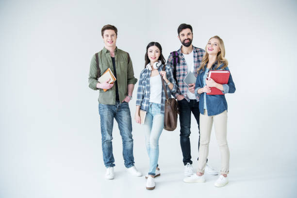 istock four young students in casual clothes holding books on white 669985868