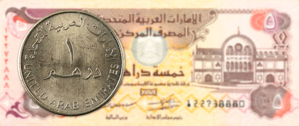 istock 1 dirham coin against 5 united arab emirates dirham bank note obverse 669989212