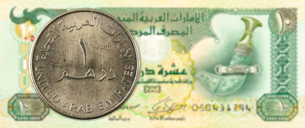 istock 1 dirham coin against 10 united arab emirates dirham bank note obverse 669989926