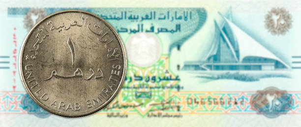istock 1 dirham coin against 20 united arab emirates dirham bank note obverse 669989980