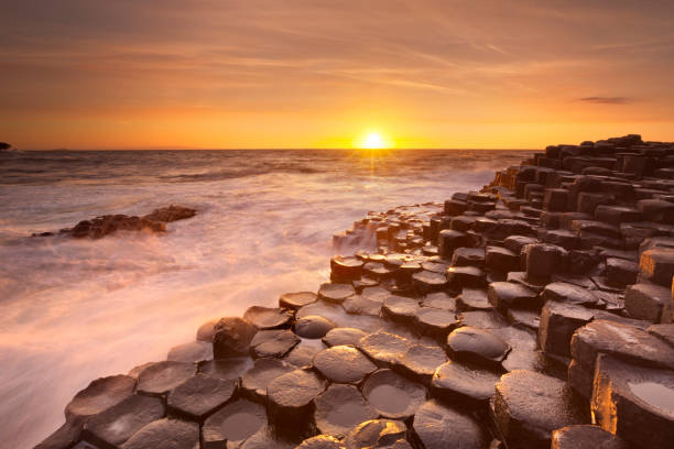 The Giant's Causeway in Northern Ireland at sunset Sunset over the basalt rock formations of Giant's Causeway on the north coast of Northern Ireland. giants causeway photos stock pictures, royalty-free photos & images
