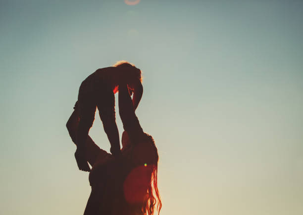 istock mother and little daughter play at sunset 669996320