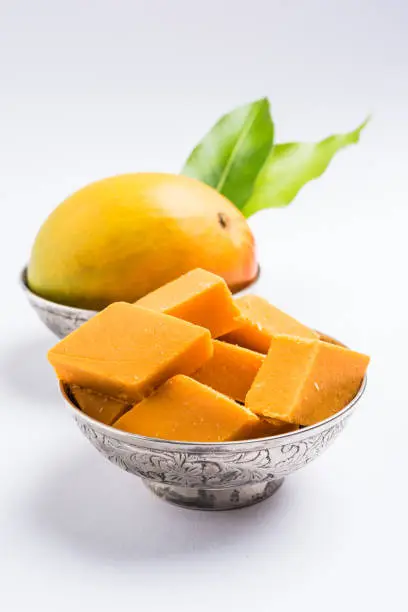 Photo of Indian sweet - traditional mango burfi or cake or bar made up of authentic alphonso or hapus mangos from konkan, india