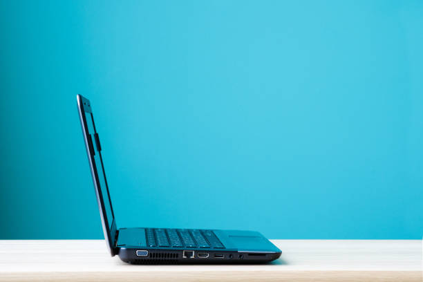 istock Computer notebook, lap-top, on office desk over green wall background, with copy space 669996722