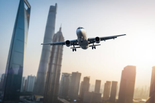 istock Airplane flies over city. 669997210