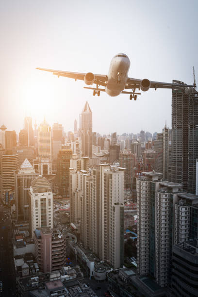 istock Airplane flies over city. 669997542