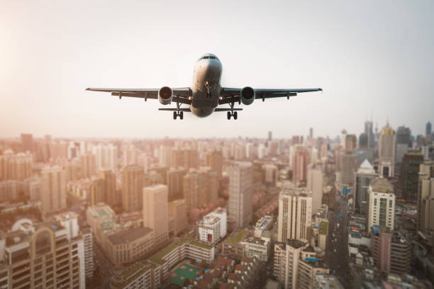 istock Airplane flies over city. 669999736