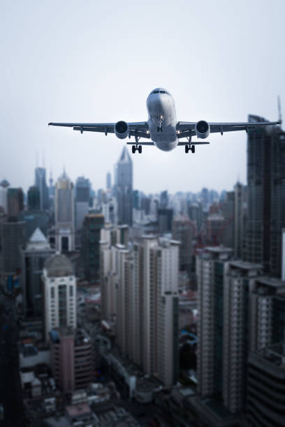 istock Airplane flies over city. 669999802