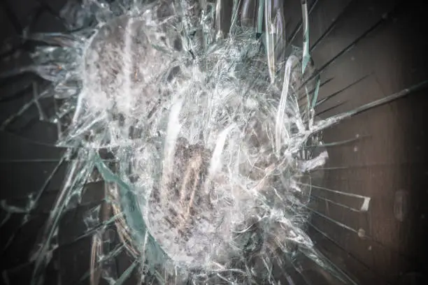 Aftermath of violent attempted robbery, shattered window glass, crime, vandalism, Dramatic post-processing,