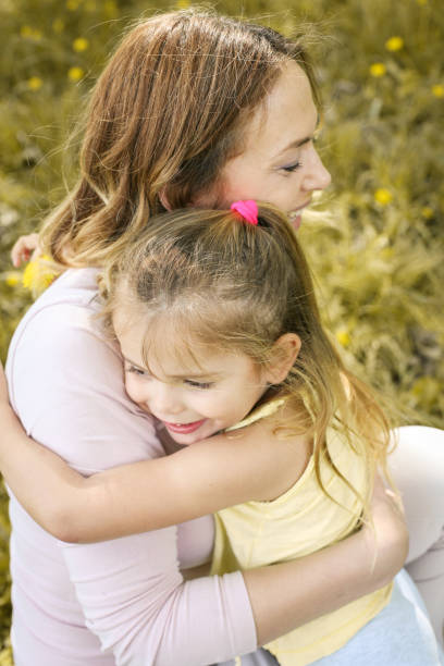 istock Mother and daughter outdoors in a meadow. 670003902