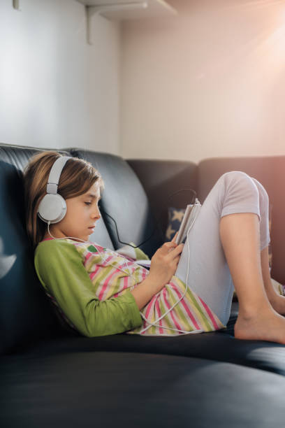 istock Girl using tablet and listening music 670004128