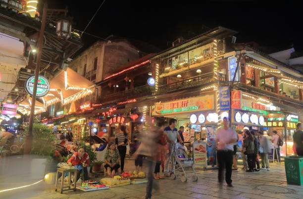 Yangshou China - November 18, 2016: People visit West street in Yangshou China. West street is a main commercial street with restaurants bars and gift shops.