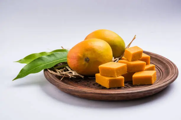 Photo of Indian sweet - traditional mango burfi or cake or bar made up of authentic alphonso or hapus mangos from konkan, india