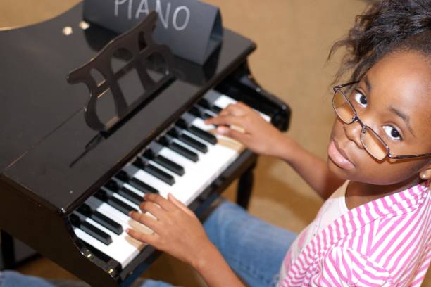 istock Black girl playing a piano 670015622