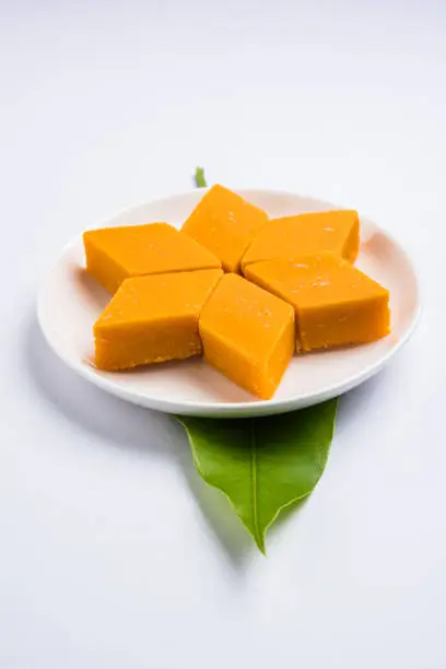 Photo of Indian sweet - traditional mango burfi or cake or bar made up of authentic alphonso or hapus mangos from konkan, india