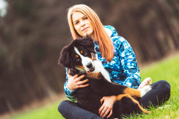istock Blonde girl on a meadow with her dog 670019068