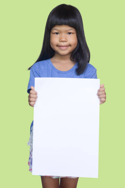 istock asian kid holding blank poster 670023572