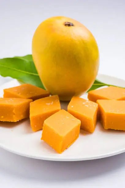 Photo of Indian sweet - traditional mango burfi or cake or bar made up of authentic alphonso or hapus mangos from konkan, india