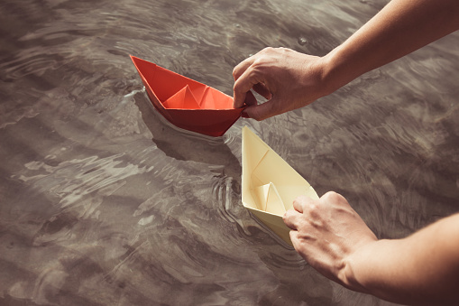 Female floating paper boats