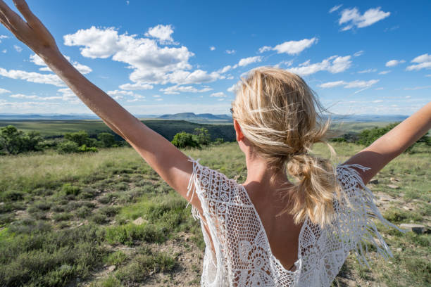 istock Young woman arms outstretched, mountain landscape 670032024