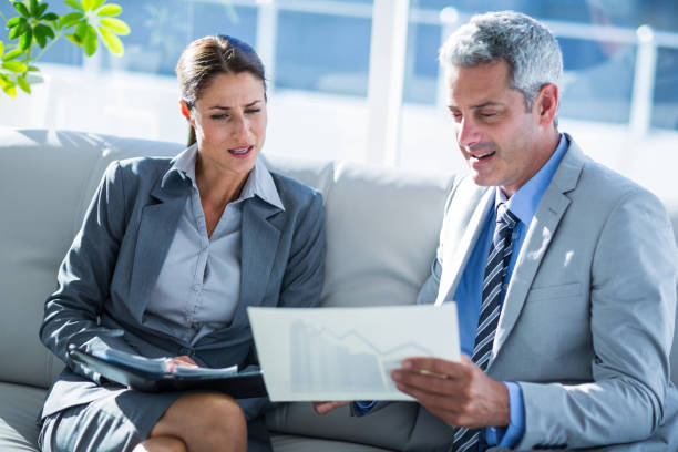istock Business people looking at graphic on paper 670033008