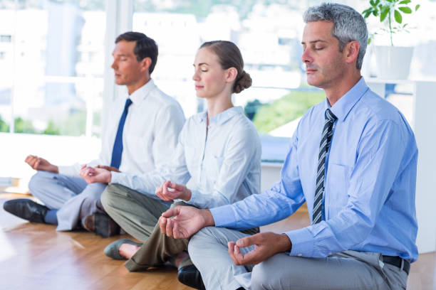 istock Business people doing yoga on floor 670037100
