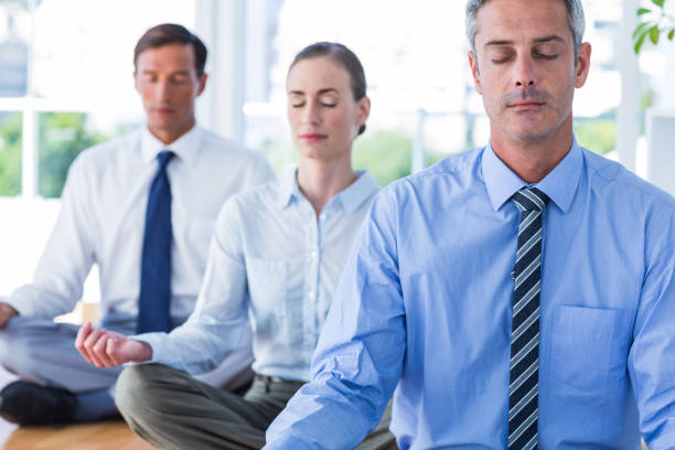 istock Business people doing yoga on floor 670037180