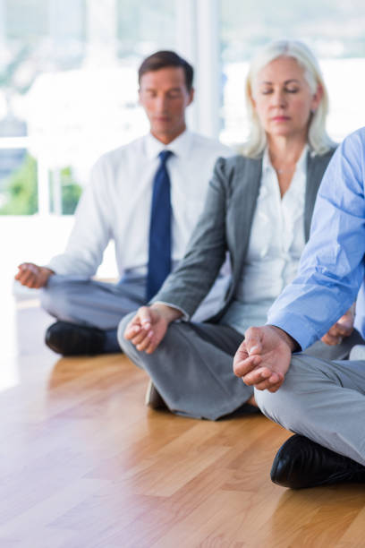 istock Business people doing yoga on floor 670037306
