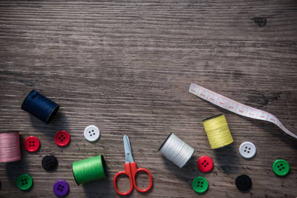 istock Sewing equipment on wooden table 670037560