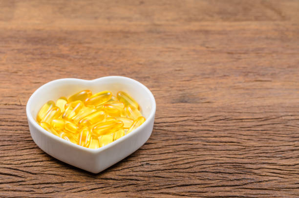 istock fish oil in heart shape bowl 670037628