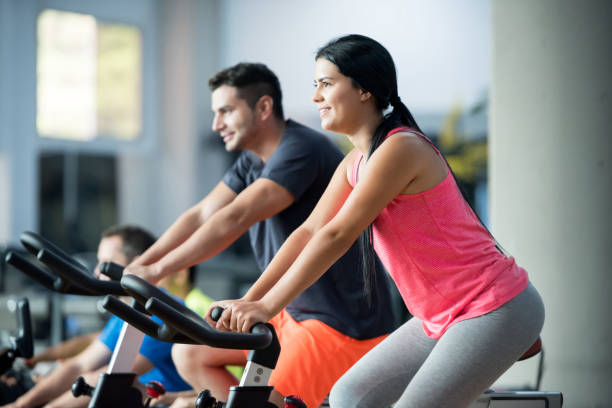 istock Happy people doing exercising at the gym 670044934