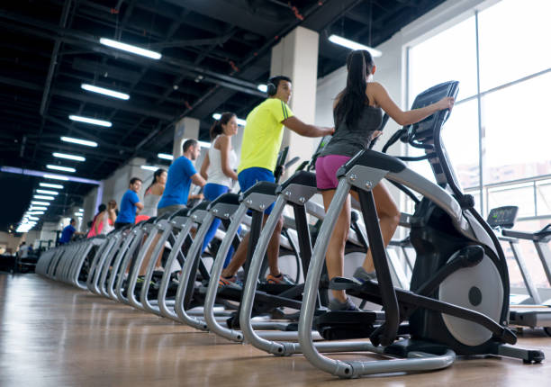 istock People at the gym exercising on cross trainers 670045034