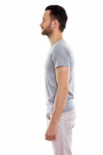 istock Profile view of young man standing against white background 670045506
