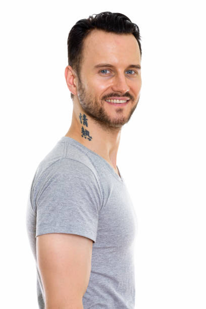 istock Studio shot of happy young man smiling while looking at camera with tattoo on neck 670045708