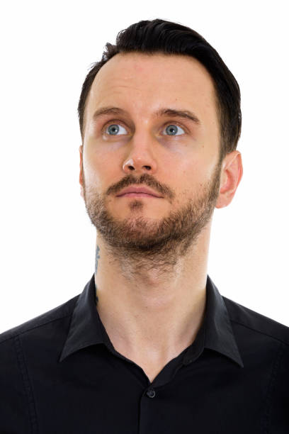 istock Face of young handsome businessman thinking while looking up 670050054