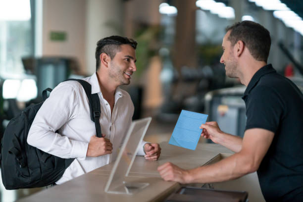 istock Man at the gym talking to receptionist about membership plans 670051228