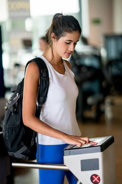 istock Woman entering the gym with a fingerprint scan 670051242