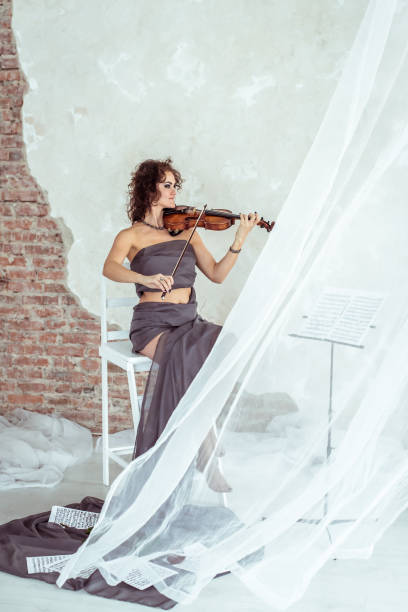 istock Beautiful woman playing the violin 670051928