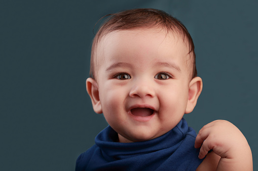 Portrait of a cute baby against color background