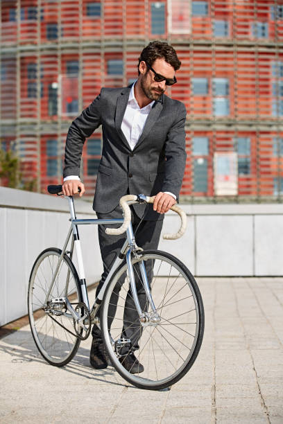 istock Businessman with bicycle standing in city 670054960