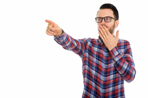 istock Studio shot of young man pointing at distance while looking shocked 670055710