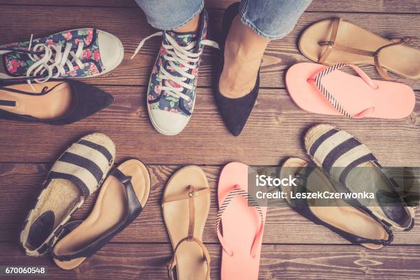 Collection Of Female Shoes On Wooden Floor Stock Photo - Download Image Now - Directly Above, Canvas Shoe, Foot